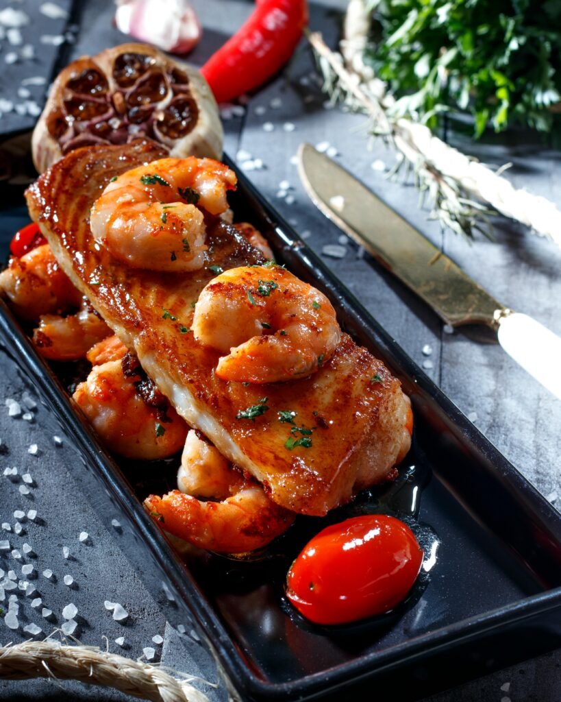 Delicious grilled shrimp and fish served with aromatic herbs and spices for a gourmet meal experience.